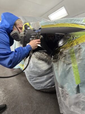 Mid-City-Collision-Image-14 Applying auto body paint to vehicle.